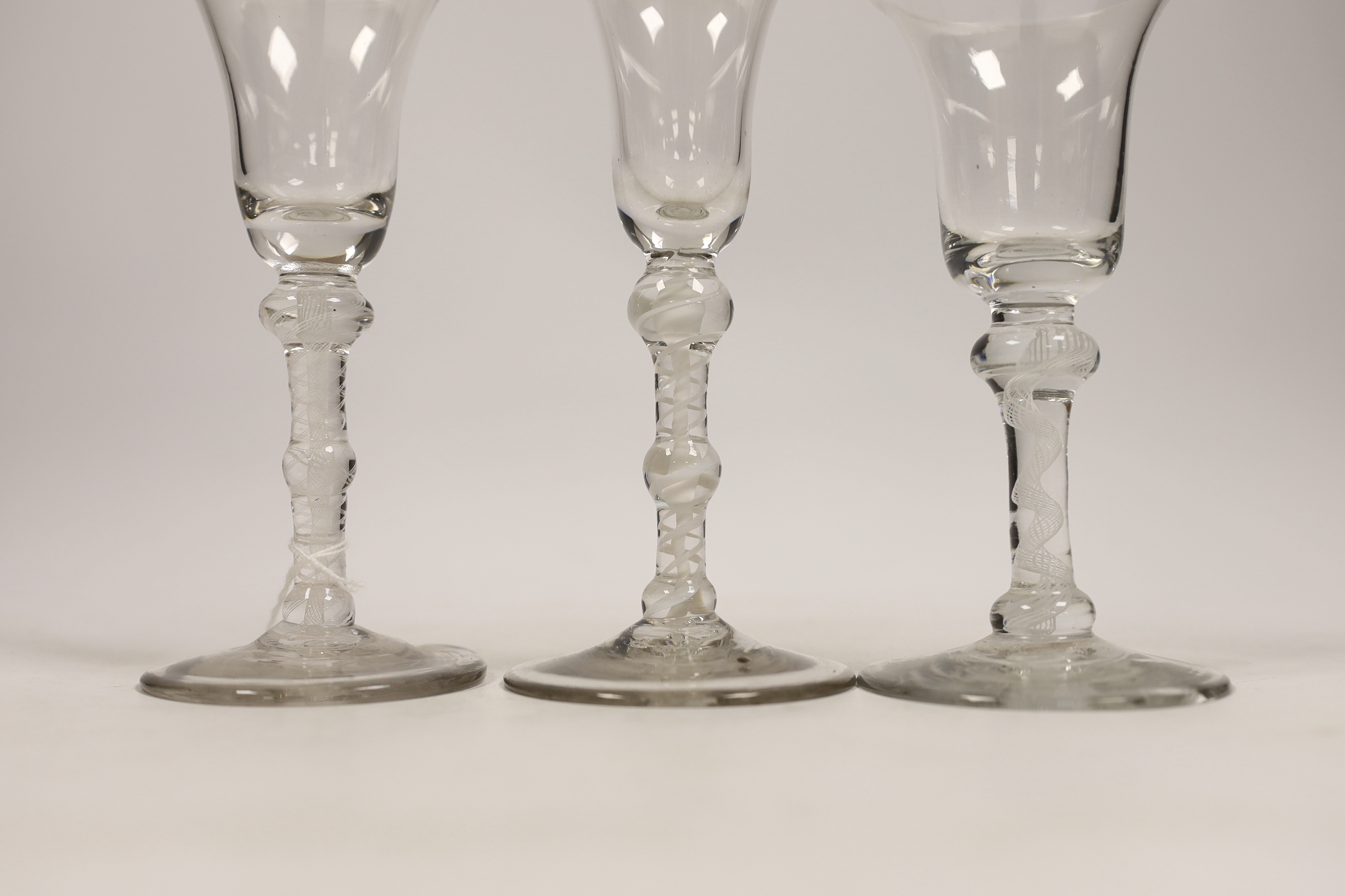 Three George III DSOT stem wine glasses, c.1760, largest 17cm high